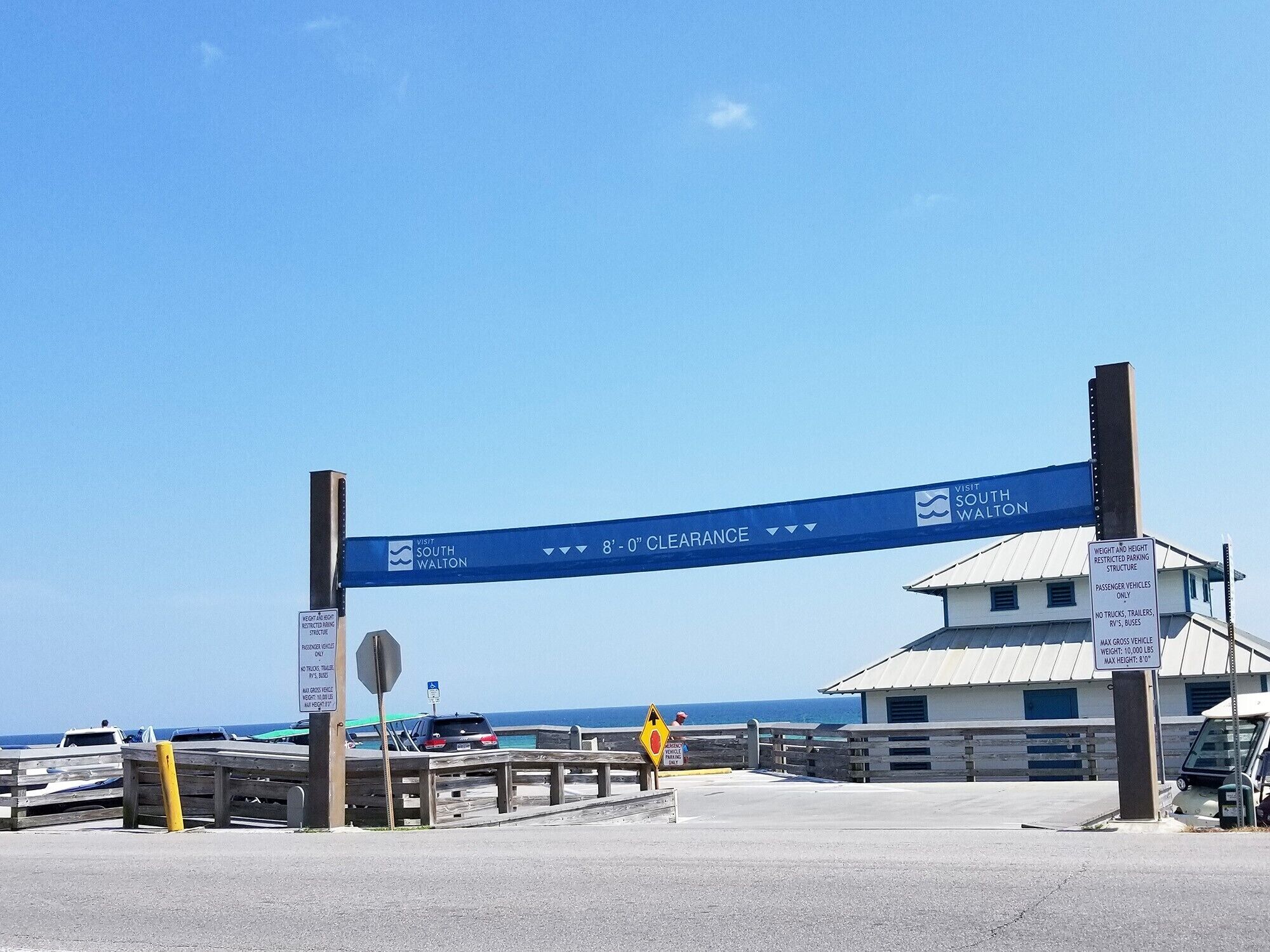 A parking area with a sign indicating 8'-0" clearance and a sign for South Walton.