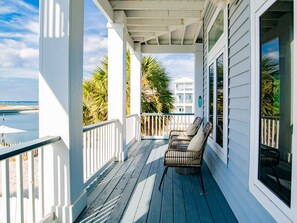 Relax on the covered porch with a view of the ocean and distant shoreline.