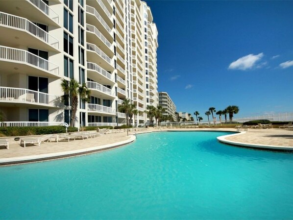 A large hotel with multiple balconies and a swimming pool. - Silver Beach Towers #1805E by Southern Vacation Rentals (Destin)