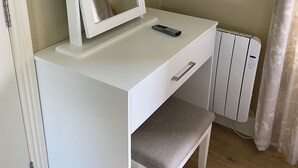 A white desk with a mirror, a remote control, and a bench. - distance 2 minutes Adare Village  Manor, Hotels, Restaurant’s, Pubs, Golf Course (Adare)
