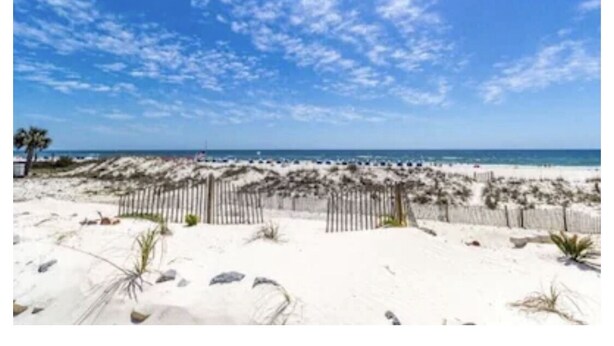 A beach with a wooden fence, sandy dunes, and a clear blue sky. - 3 Bedroom, Gulf View, Orange Beach Condo--A Boardwalk to Salt Life (Orange Beach)