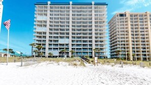 A multi-story hotel with a modern design, featuring a large number of balconies and a beach view. - Bluewater #403 by Southern Vacation Rentals (Orange Beach)
