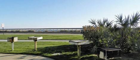 A parking area with concrete pathways and mailbox posts.