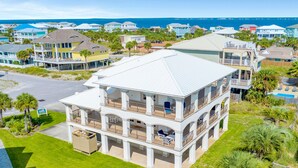 A multi-story beachfront property with balconies, a swimming pool, and a view of the ocean. - Juela on the Beach by Southern Vacation Rentals (Pensacola Beach)