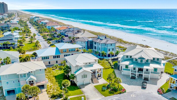 A coastal residential area with houses, a beach, and a clear sky. - Juela on the Beach by Southern Vacation Rentals (Pensacola Beach)