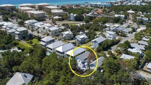 An aerial view of a coastal residential area with houses, a large hotel complex, and a view of the ocean. - Dune Our Thing by Southern Vacation Rentals (Santa Rosa Beach)