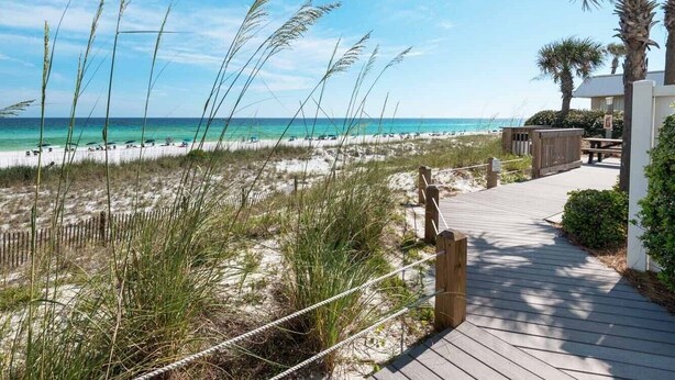 A wooden boardwalk leading to a beach with sand dunes and tall grasses. - Crystal Sands #311A by Southern Vacation Rentals (Destin)