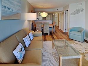 Relax in this stylish living room with a comfortable sofa, coffee table, and dining area.
