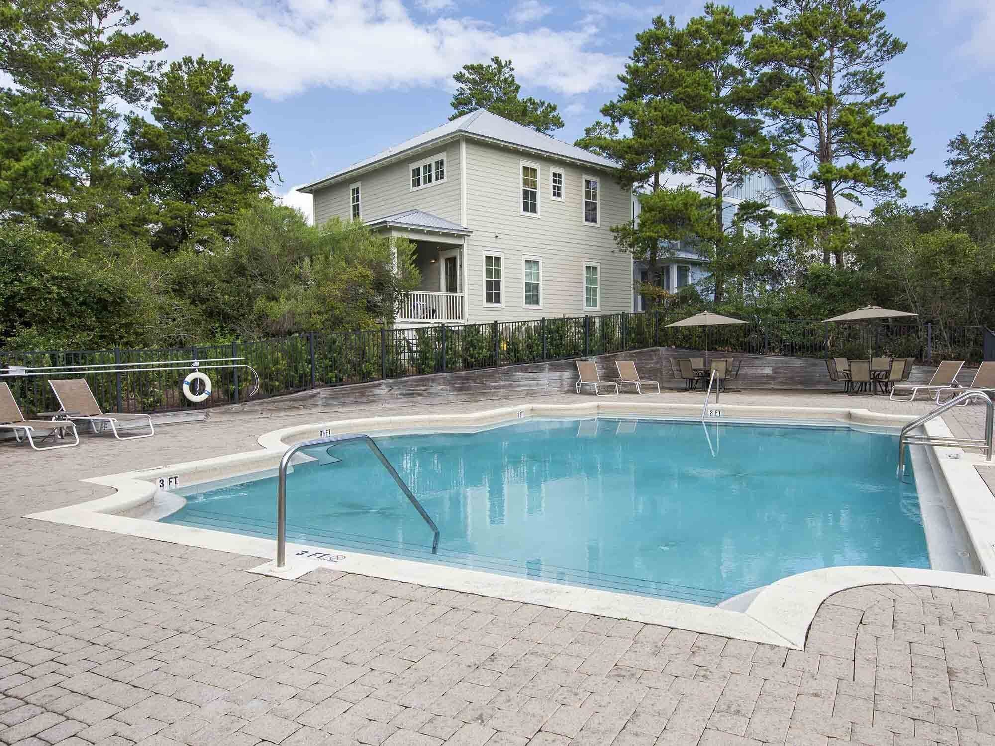 A rectangular swimming pool with a metal ladder and a 3 FT depth marker.