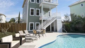 A multi-story house with a balcony, a swimming pool, and outdoor furniture. - The Taj Mahal by Southern Vacation Rentals (Santa Rosa Beach)