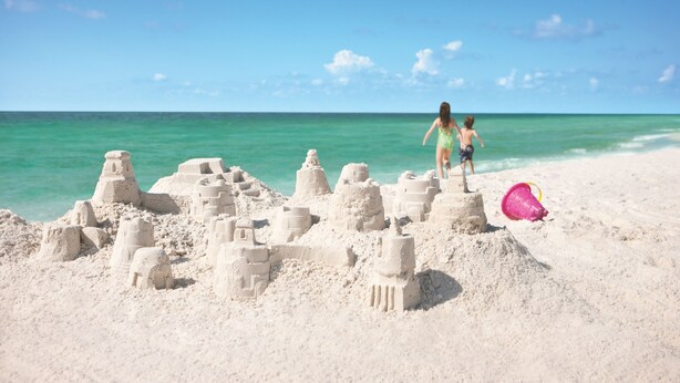 A sandy beach with sand sculptures and a clear blue sky. - The Taj Mahal by Southern Vacation Rentals (Santa Rosa Beach)