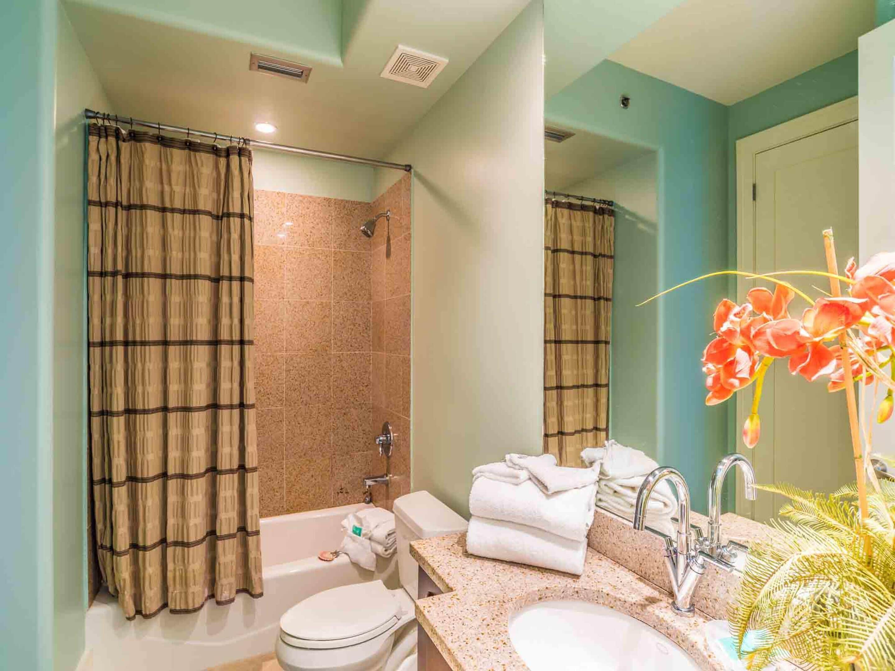 A bathroom with a bathtub, toilet, and sink.