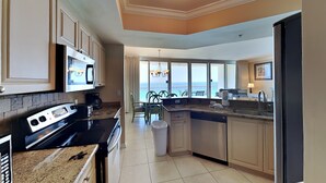 A modern kitchen with a large island, built-in appliances, and a view to the outside. - Silver Shells St. Maarten #1405 by Southern Vacation Rentals (Destin)