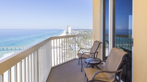 A balcony with two wicker chairs, a view of the ocean, and a pier in the distance. - Calypso Resort & Towers #1809W by Resort Collection (Panama City Beach)
