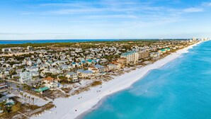An aerial view of a coastal town with beachfront properties, a sandy beach, and a clear blue ocean. - Already There by Southern Vacation Rentals (Destin)