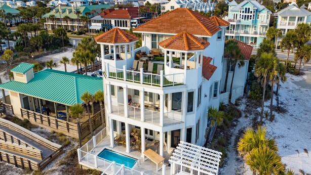 A multi-story beachfront property with a pool, balconies, and a beach access deck. - Already There by Southern Vacation Rentals (Destin)