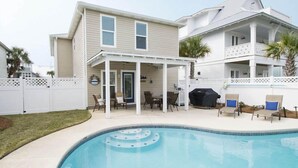 A two-story house with a covered patio and a swimming pool. - Ocean Breeze by Southern Vacation Rentals (Destin)