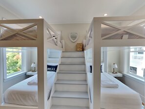 A hotel room with bunk beds, a heart-shaped mirror, and a 'RELAX' sign on the bed. - Sea La Vie In Grayton Beach by Southern Vacation Rentals (Santa Rosa Beach)