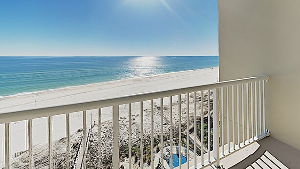 A balcony with a view of a beach and a pool. - Escapes to the Shores #704 by Southern Vacation Rentals (Orange Beach)