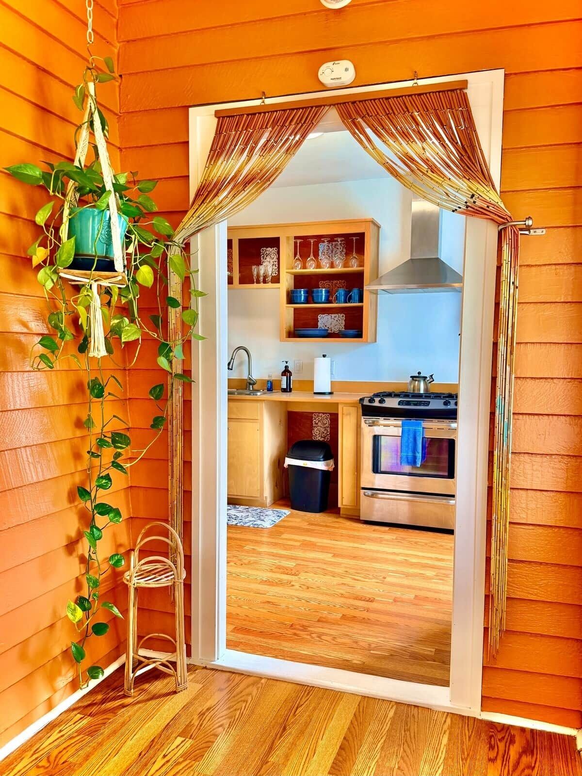 A kitchen with wooden cabinets, a sink, and an oven.