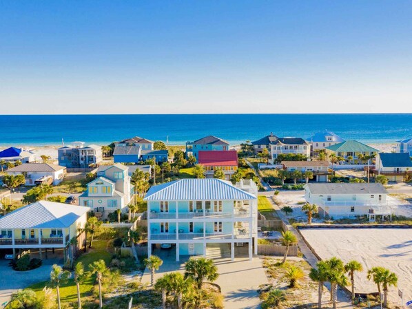 A coastal residential area with houses and a beach. - She Sells Seashells by Southern Vacation Rentals (Pensacola Beach)