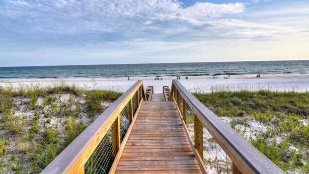 A wooden boardwalk leading to a beach with sand dunes and the ocean in the background. - Happy as a Clam by Southern Vacation Rentals (Santa Rosa Beach)