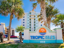 A hotel entrance with a sign reading 'TROPIC ISLES 433'.