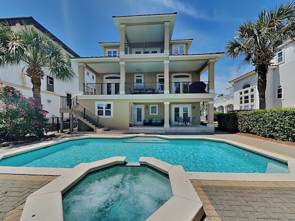 A multi-story building with a swimming pool in front.