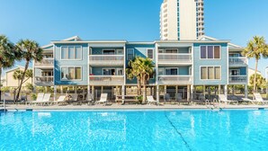 A hotel with a swimming pool, multiple balconies, and a tall building in the background. - Sea Oats by Southern Vacation Rentals (Gulf Shores)