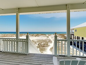 A wooden deck with white railings overlooking a beach. - Anderson Beach House by Southern Vacation Rentals (Orange Beach)