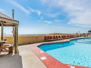 Relax by the pool with a stunning beach view.