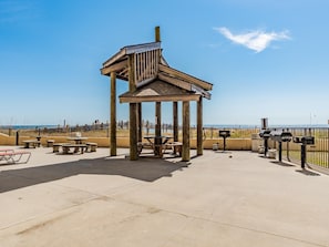 Relax in this serene gazebo, surrounded by ocean views and a tranquil patio area.