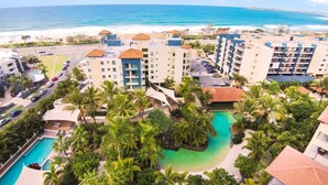 A resort with multiple buildings, a swimming pool, and a beach view. - Seaforth Resort (Alexandra Headland)