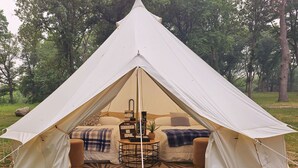 A tent with a bed, a small table, and a welcome sign. - Lovers Lookout 3 at Big Rock Creek (Saint Croix Falls)
