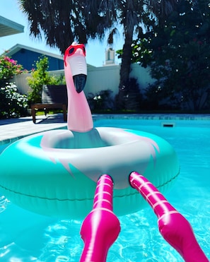 A swimming pool with a pink inflatable float and a person lying on it. -  Tropical Beach Bungalow w/Private Saltwater Pool and Additional Casita (St. Pete Beach)