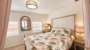 A bedroom with a bed, a mirror, two bedside lamps, and a window with blinds. -  Tropical Beach Bungalow w/Private Saltwater Pool and Additional Casita (St. Pete Beach)