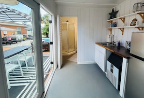 A narrow kitchen with a built-in dishwasher, a sink, and a small countertop. -  FALL DISCOUNT! Tropical Beach Bungalow w/Private Saltwater Pool and Pool House (St. Pete Beach)