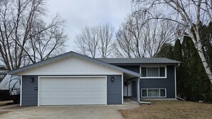 A two-story house with a garage and a covered porch. - All you need for your home away from home in MN (Sauk Rapids)