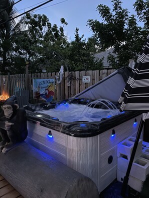 A hot tub with a wooden deck, a wooden fence, and a sign that says "Please No Peeing in the Pool". - Unique 2 bedroom with fun outdoor area and hot tub (Lantana)