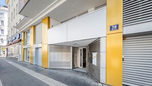 A building with a closed shutter on the right, a visible number 38 sign, and a clear pedestrian path with tactile paving. - Sunny Brigittenau 1BR w/ Elevator & Storage, nr Augarten, by Blueground (Vienna)