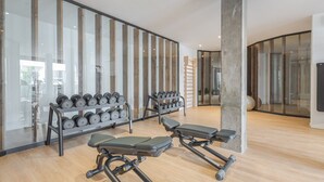 A gym with exercise equipment, including dumbbells and a bench. - Colinas - Ancor 0.3 POOL VIEW 1B (Arona)