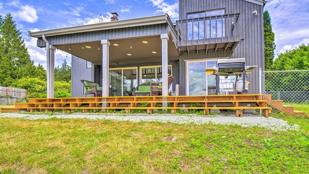 A modern two-story house with a covered porch and a deck. - Stunning Hood Canal Getaway w/ Private Deck! (Belfair)