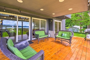 Relax on the spacious deck with comfortable wicker furniture and enjoy the view of the lush landscape through the large sliding glass doors.
