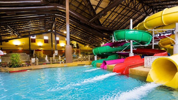 An indoor water park with multiple water slides and a pool. - Large North Conway Vacation Home Indoor Pool, Pool Table Sleeps 22 (Conway)