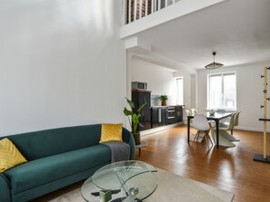 Relax in this spacious living area with a sofa, coffee table, and dining space.