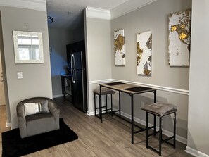 Enjoy cooking in this well-equipped kitchen with a refrigerator, oven, and comfortable seating area.