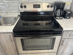 Luxury Condo | Private kitchen | Full-size fridge, microwave, oven, stovetop