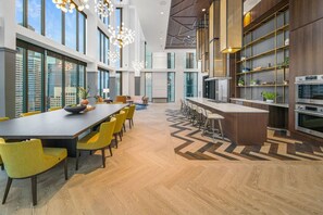 Enjoy meals in the spacious dining area with a long table and comfortable seating.