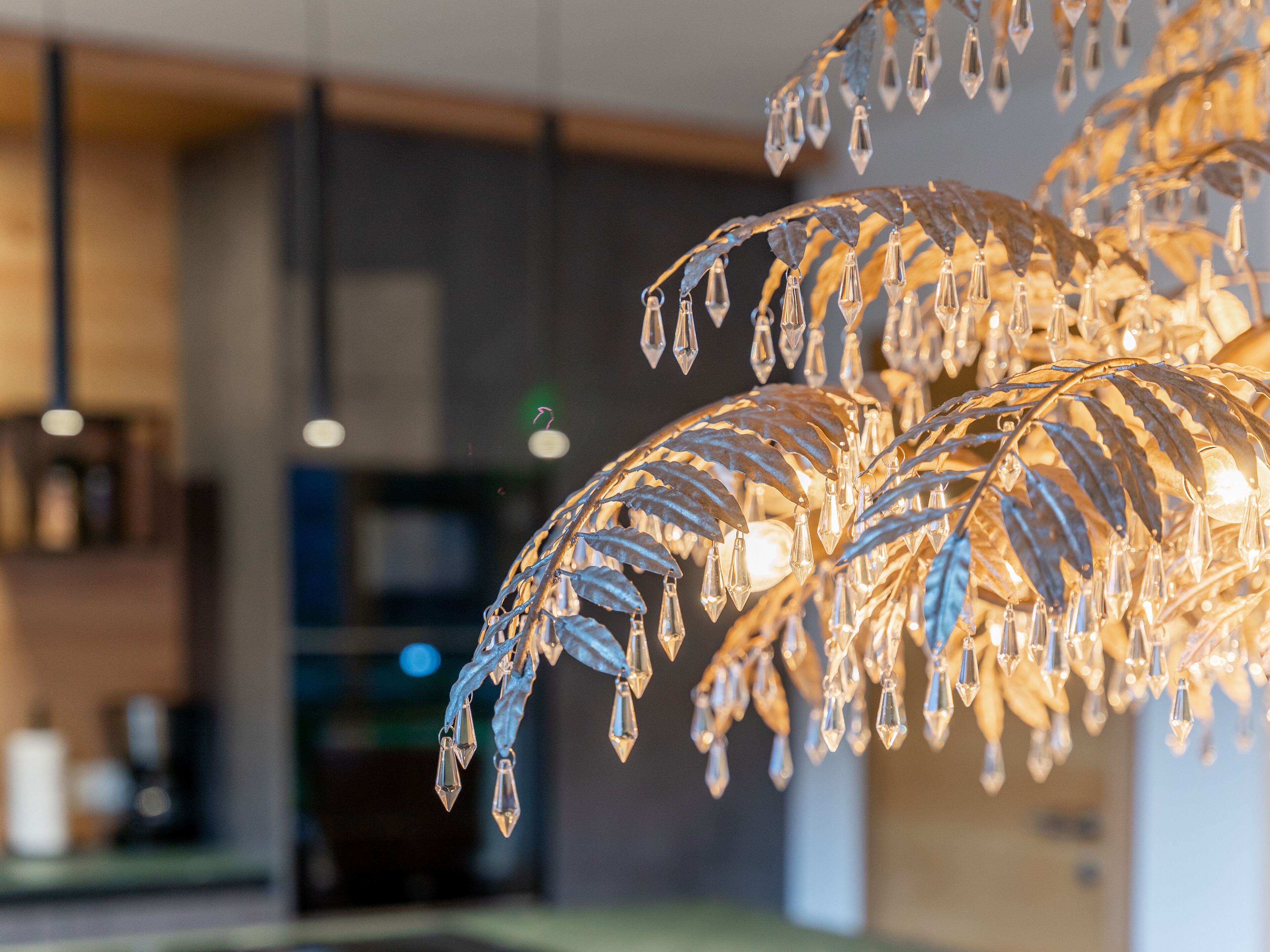 A chandelier with crystal elements in a modern interior setting.