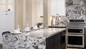 A modern kitchen with a marble countertop, built-in oven, and white cabinetry. - Pet-friendly! Near downtown Oceanside - Sea Spray (Oceanside)
